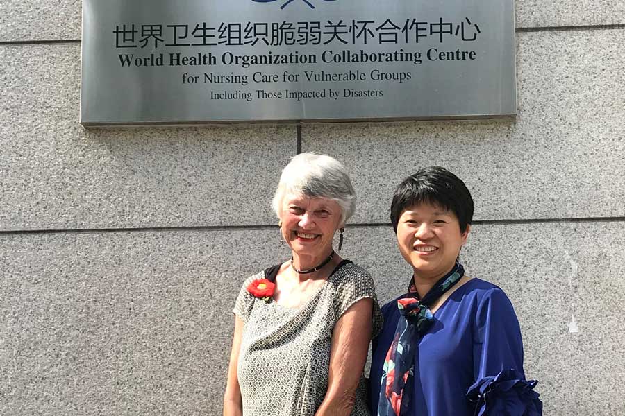 Liu McFarlane in front of the WHO with a research colleague.