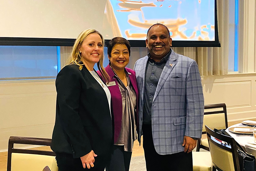 Jeanna Ratnayake, Dean Rama Yelkur and Dilshan Ratnayake stand in the TWU ballroom