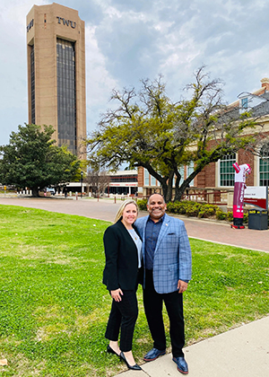 Jeanna and Dilshan Ratnayake stand outside in front of TWU Administration Conference Tower