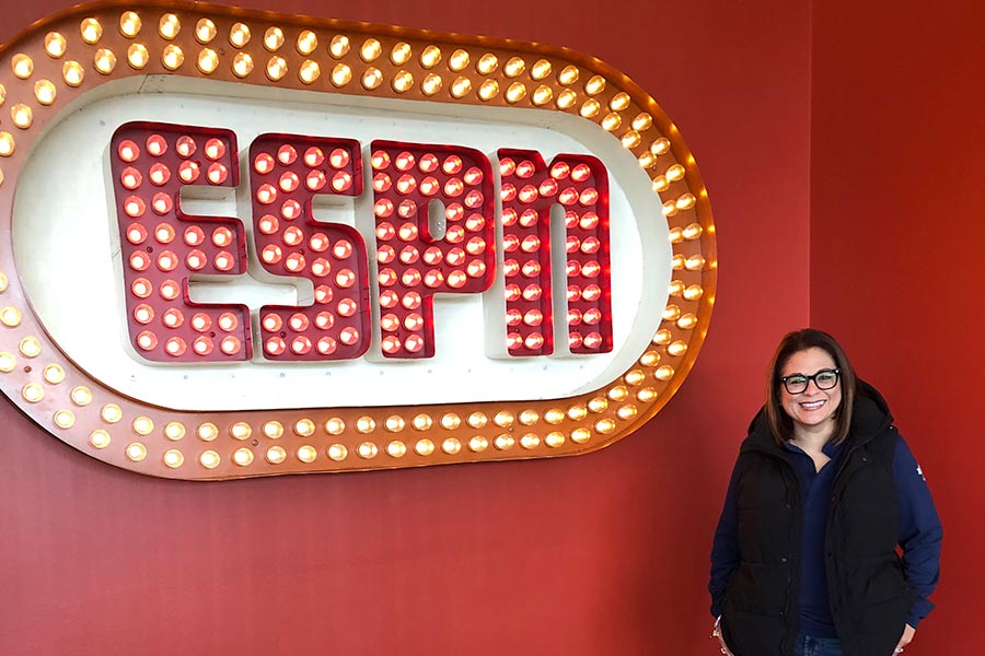 Vanessa Miranda stands next to a ESPN sign