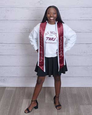 Hana Taylor Schlitz in her graduation stole and a TWU sweatshirt.