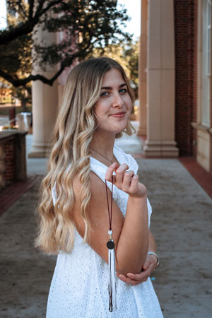 Lauren Murphy holds up her TWU graduation tassle.