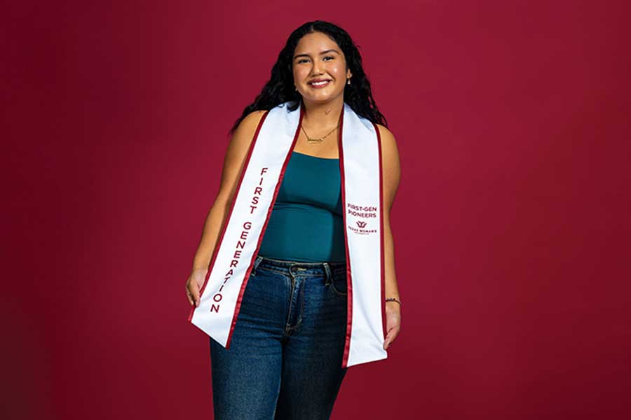 A TWU student portrait on a maroon background wearing a stole that says "First-Generation" on it.