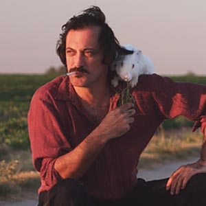 a man sitting in the middle of a road