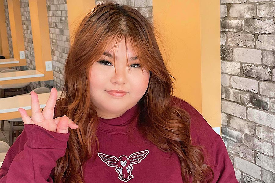 TWU student Brittney Lay in a maroon TWU sweatshirt