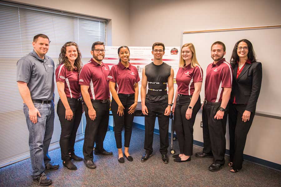 TWU Acolytes of Apollo Spring Team and professors show off garment designed for astronauts