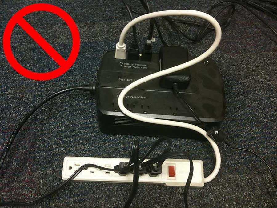 A power strip plugged into a UPS strip