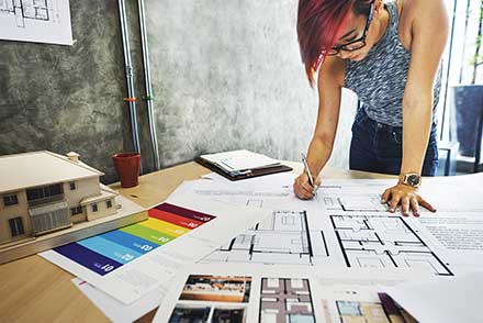 A TWU student working with plans